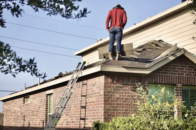 Professional roofer working on a residential roof in Freewood Acres